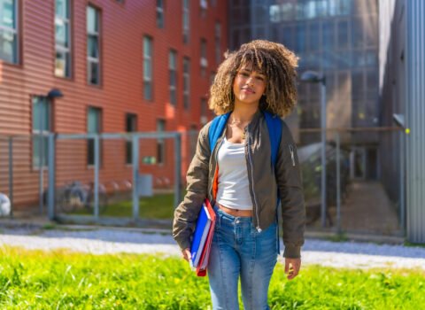 Beauty latin student standing outside the university