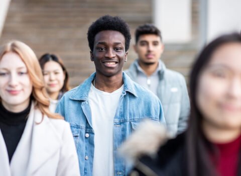 Multiracial crowd of people in the city commuting and walking on